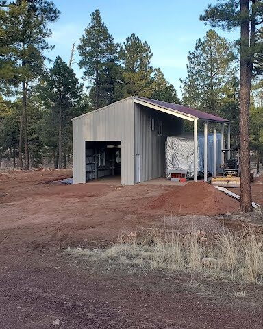 Modern galvanized steel cabins in Fortuna Foothills, Arizona, showcasing durability and contemporary design against a scenic backdrop